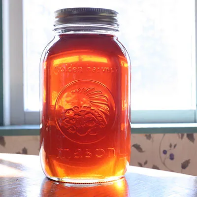 quart jar of maple syrup in the sun